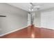 Bedroom featuring gray walls, hardwood floors, closet, and modern lighting at 2746 Heathgate Way, Land O Lakes, FL 34638