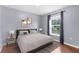 Bedroom featuring gray walls, hardwood floors, large window and decorative lamps at 2746 Heathgate Way, Land O Lakes, FL 34638