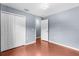 Bedroom featuring gray walls, hardwood floors, closet, and modern lighting at 2746 Heathgate Way, Land O Lakes, FL 34638
