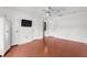 This is a bright bedroom with a closet, television on the wall, ceiling fan, and a view of the en-suite bathroom at 2746 Heathgate Way, Land O Lakes, FL 34638