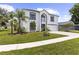 Two story home with a well-manicured lawn and mature palm trees at 2746 Heathgate Way, Land O Lakes, FL 34638