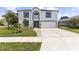 Charming two-story home with an arched window and meticulously maintained lawn at 2746 Heathgate Way, Land O Lakes, FL 34638