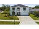 Charming two-story home with a well-manicured lawn, complemented by lush landscaping at 2746 Heathgate Way, Land O Lakes, FL 34638