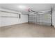 Spacious two car garage with an automatic door and built-in shelving at 2746 Heathgate Way, Land O Lakes, FL 34638