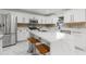 Bright open kitchen features a center island with seating and stainless steel appliances at 2746 Heathgate Way, Land O Lakes, FL 34638