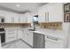 Bright kitchen features white cabinets, modern appliances, granite countertops, and stylish backsplash at 2746 Heathgate Way, Land O Lakes, FL 34638