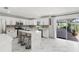 Bright open kitchen features a center island with seating and a sliding door to outdoor patio at 2746 Heathgate Way, Land O Lakes, FL 34638