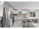 Bright open kitchen features a center island with seating and stainless steel appliances at 2746 Heathgate Way, Land O Lakes, FL 34638