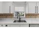 Close-up of a kitchen backsplash with a view of the outdoor patio at 2746 Heathgate Way, Land O Lakes, FL 34638