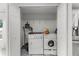 Convenient laundry room with washer, dryer, and storage space, next to the kitchen at 2746 Heathgate Way, Land O Lakes, FL 34638