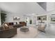 Bright living room with elegant floors, a comfy sofa, and stylish decor at 2746 Heathgate Way, Land O Lakes, FL 34638