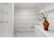 Walk-in pantry with ample shelving for organized storage with marble floor at 2746 Heathgate Way, Land O Lakes, FL 34638