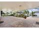 An expansive screened-in patio showcases decorative tile flooring and meticulously maintained garden at 2746 Heathgate Way, Land O Lakes, FL 34638