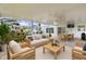 This screened-in patio features a living area, an outdoor dining area, and beautiful landscaping at 2746 Heathgate Way, Land O Lakes, FL 34638