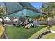 A colorful playground under a canopy, featuring multiple slides and climbing structures, with padded ground for safety and fun at 2746 Heathgate Way, Land O Lakes, FL 34638