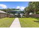 A covered playground features a padded ground, slides, and play equipment, surrounded by green grass, and secured by a fence at 2746 Heathgate Way, Land O Lakes, FL 34638