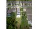 An aerial view of the property featuring a screened pool, basketball court, and fenced backyard at 3052 Living Coral Dr, Odessa, FL 33556