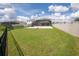 Spacious, well-maintained backyard with a screened-in pool area and secure fencing, perfect for outdoor activities at 3052 Living Coral Dr, Odessa, FL 33556
