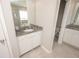 Bright bathroom with tile flooring, granite countertop, and a glass-door shower in the background at 3052 Living Coral Dr, Odessa, FL 33556