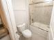 Modern bathroom featuring a tiled shower with glass door, granite countertops, and a white toilet at 3052 Living Coral Dr, Odessa, FL 33556