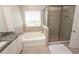 An elegant bathroom features a large soaking tub and a glass-enclosed shower at 3052 Living Coral Dr, Odessa, FL 33556