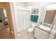 Bright bathroom featuring a tiled shower with glass door, granite countertop, and artistic decor at 3052 Living Coral Dr, Odessa, FL 33556