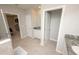 Bright bathroom featuring tile floors, white cabinets, granite countertops, and a separate toilet room at 3052 Living Coral Dr, Odessa, FL 33556