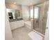 A luxurious bathroom showcases a glass shower, a soaking tub, and elegant tile work at 3052 Living Coral Dr, Odessa, FL 33556