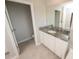 Bathroom featuring tile floors, a white vanity with granite countertop, and a separate toilet room at 3052 Living Coral Dr, Odessa, FL 33556