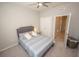 Comfortable bedroom features a ceiling fan, carpet flooring, and neutral tones at 3052 Living Coral Dr, Odessa, FL 33556