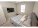 Bright bedroom with a comfortable bed, soft linens, and natural light from the window at 3052 Living Coral Dr, Odessa, FL 33556