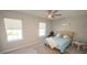 Comfortable bedroom with neutral walls, carpeted floors, two windows, and stylish decor at 3052 Living Coral Dr, Odessa, FL 33556
