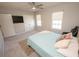 Bedroom featuring carpeted floors, two windows, neutral walls, and a ceiling fan at 3052 Living Coral Dr, Odessa, FL 33556