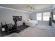 Stylish bedroom featuring a bed, desk, carpeted floors, and windows for natural light at 3052 Living Coral Dr, Odessa, FL 33556