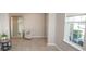Bright entryway featuring neutral tones, tile flooring, and a large mirror at 3052 Living Coral Dr, Odessa, FL 33556