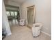 Inviting entryway with tile flooring, neutral colors, and a large mirror at 3052 Living Coral Dr, Odessa, FL 33556