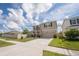 Two-story home with front porch seating and an attached two-car garage at 3052 Living Coral Dr, Odessa, FL 33556