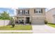 Charming two-story home with covered porch, stone accents, and two-car garage at 3052 Living Coral Dr, Odessa, FL 33556