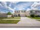 Two-story home featuring front porch seating and a two-car garage at 3052 Living Coral Dr, Odessa, FL 33556