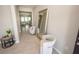 Bright foyer with tile flooring, decorative mirror, and comfortable seating at 3052 Living Coral Dr, Odessa, FL 33556