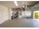 Epoxy-coated garage with ample storage space, EV charger, and well-lit interiors at 3052 Living Coral Dr, Odessa, FL 33556