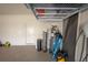 Clean garage with epoxy flooring, EV charger, and convenient storage solutions at 3052 Living Coral Dr, Odessa, FL 33556