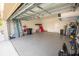 Epoxy floored garage featuring ample storage and space for parking or hobbies at 3052 Living Coral Dr, Odessa, FL 33556