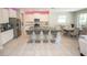 Modern kitchen featuring stainless steel appliances, a center island with seating, and open dining area at 3052 Living Coral Dr, Odessa, FL 33556