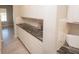 Additional kitchen features include white cabinets, stylish countertops, and tile backsplash at 3052 Living Coral Dr, Odessa, FL 33556