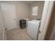 Functional laundry room featuring modern washer and dryer, utility sink, and tile flooring at 3052 Living Coral Dr, Odessa, FL 33556