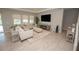 Comfortable living room with tile floors, neutral furniture, and modern entertainment center at 3052 Living Coral Dr, Odessa, FL 33556