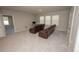 Well-lit living room with neutral carpeting, comfortable couches, and three bright windows at 3052 Living Coral Dr, Odessa, FL 33556