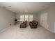 Spacious living room with plush carpeting, featuring comfortable seating and bright natural light at 3052 Living Coral Dr, Odessa, FL 33556
