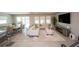 Open-concept living area with tile floors, comfortable furniture, and a dining area with ample natural light at 3052 Living Coral Dr, Odessa, FL 33556
